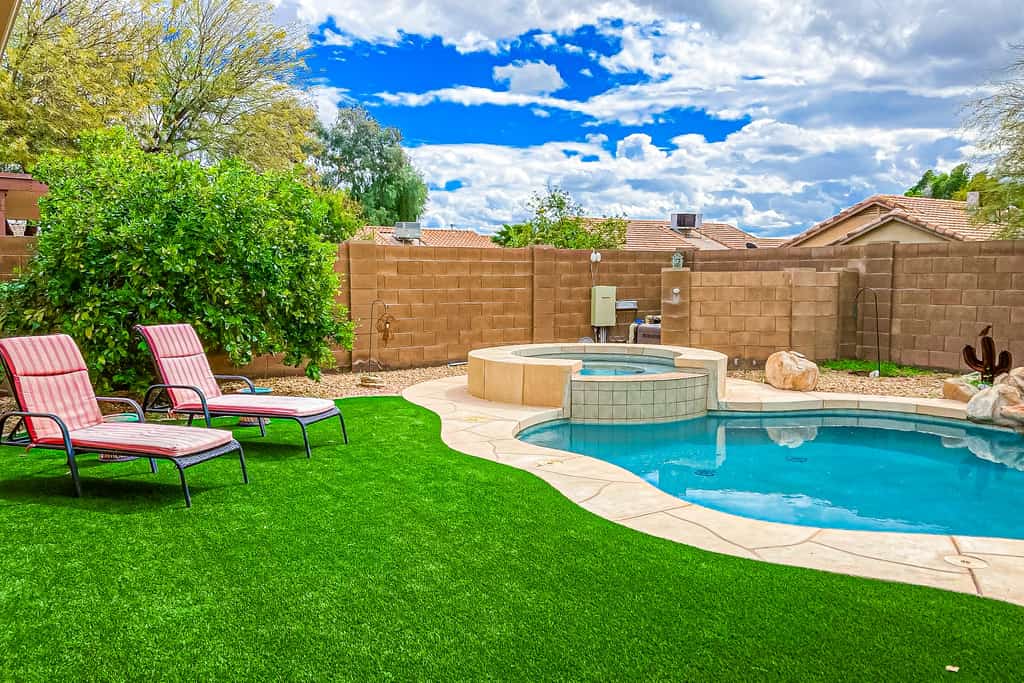 Desert charmer with enclosed yard, heated pool, smart TVs, W/D, & full kitchen