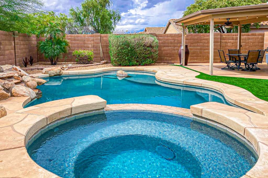 Desert charmer with enclosed yard, heated pool, smart TVs, W/D, & full kitchen