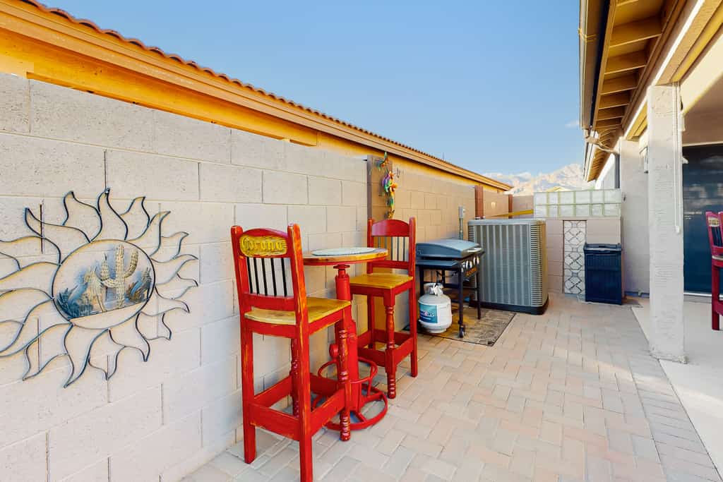 Southwestern home with colorful patio, sparkling pool, grill & dart board