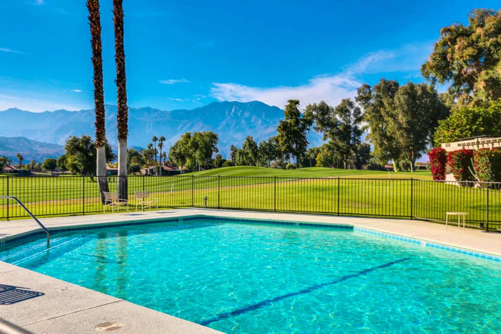 home w/ a patio & shared pool plus fairway & mountain views