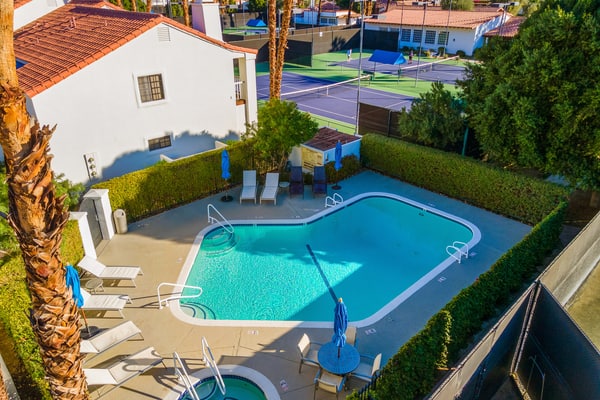 Palm-lined mountain view condo with heated pool, tennis, grill, fireplace, & AC