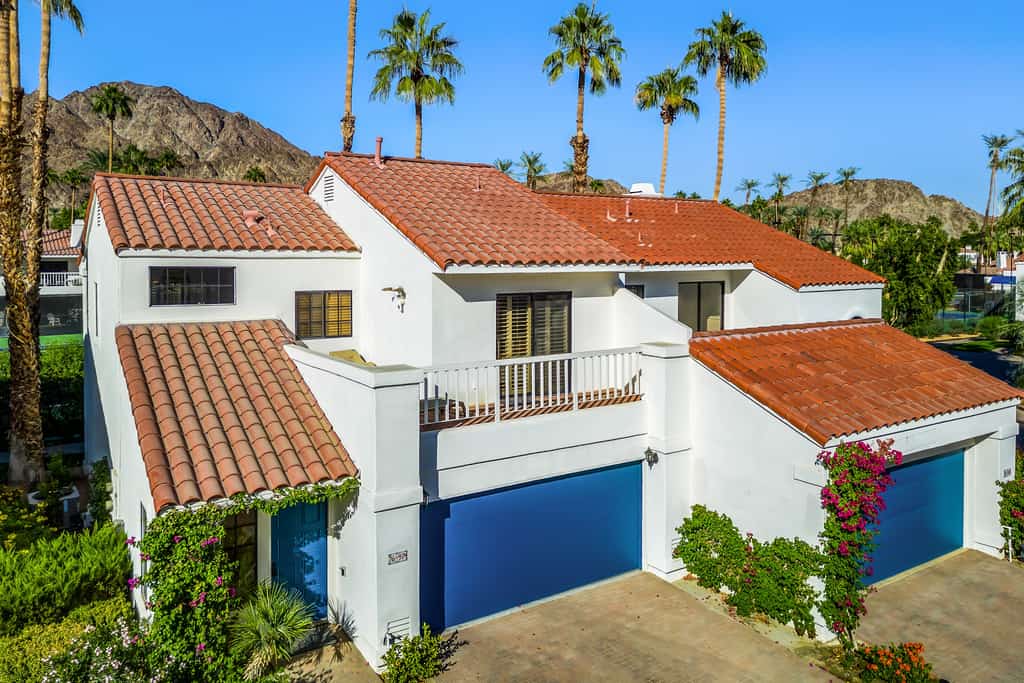 Palm-lined mountain view condo with heated pool, tennis, grill, fireplace, & AC