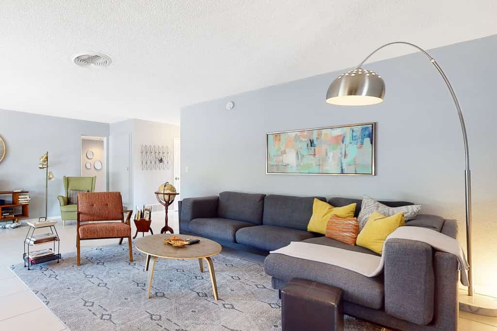Sun-soaked oasis with a pool, covered patio, grill, modern interior, W/D, & AC