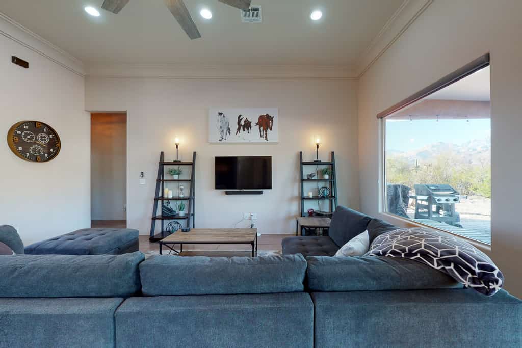 Updated home with mountain views, a private patio, grill, EV charger, W/D, & AC