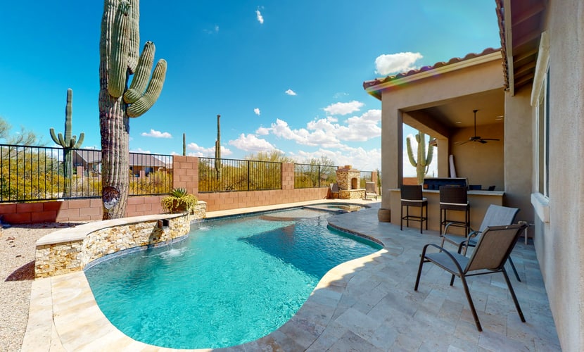 Southwestern stunner with enclosed yard, pool, putting green, & grill