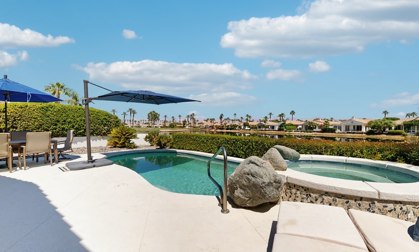 Waterfront, golf-view home w/ a private pool, pool spa, & outdoor dining area