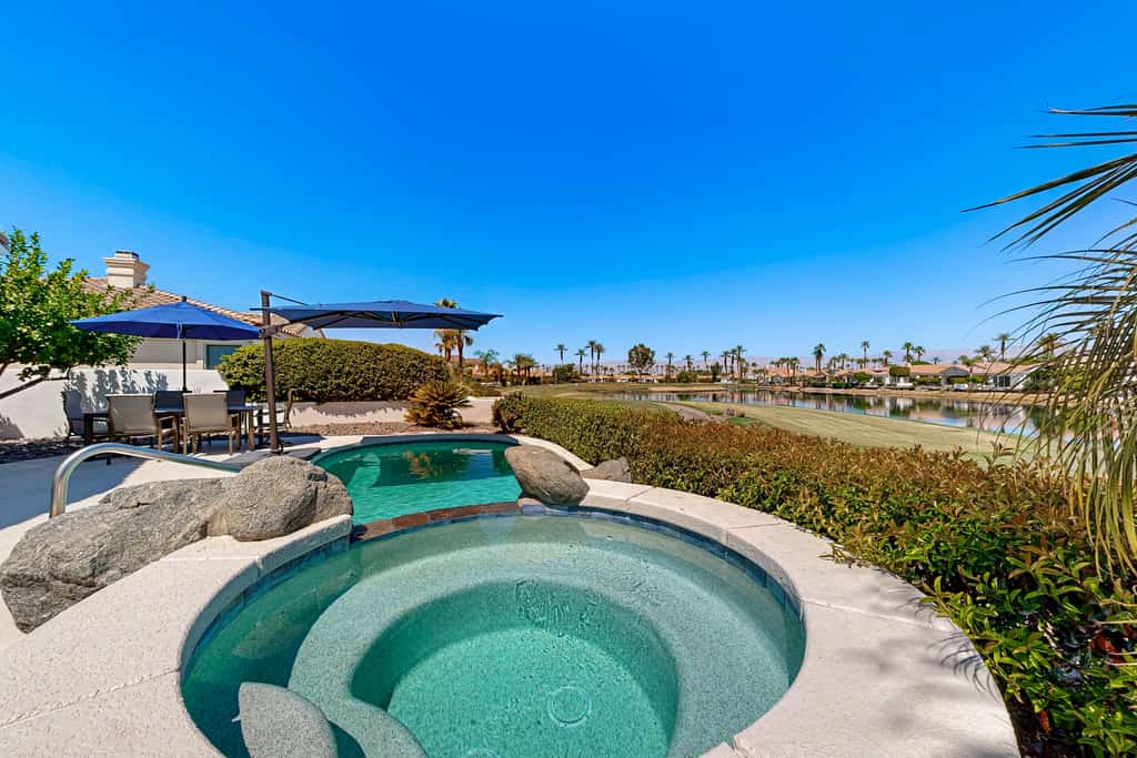 Waterfront, golf-view home w/ a private pool, pool spa, & outdoor dining area