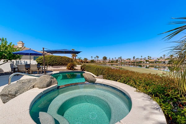 Waterfront, golf-view home w/ a private pool, pool spa, & outdoor dining area