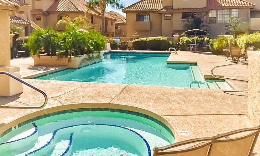 Inviting desert oasis with modern decor, pool, and hot tub