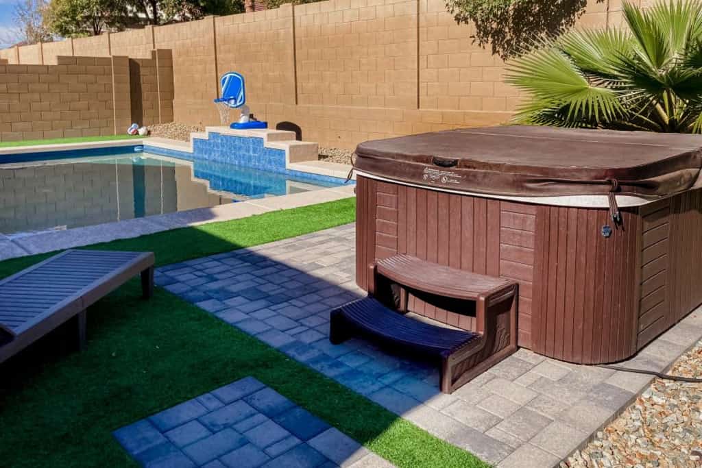 Single-story home with enclosed yard, private pool, hot tub, patio, & grill