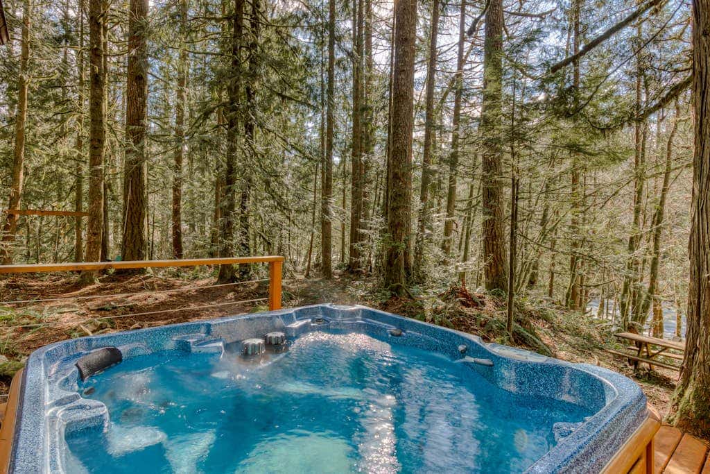 Rustic lodge with private hot tub, fireplace & riverfront views  - dog-friendly