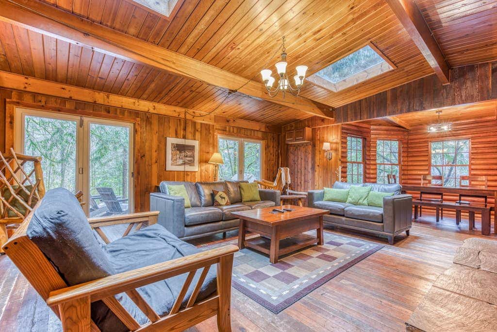 Rustic lodge with private hot tub, fireplace & riverfront views  - dog-friendly