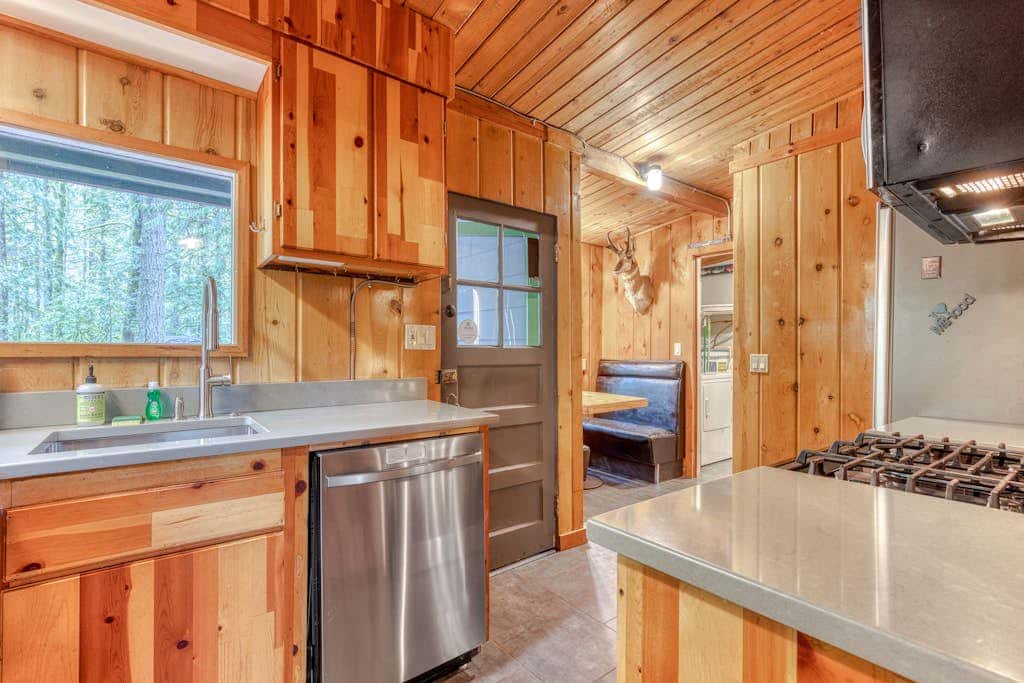 Rustic lodge with private hot tub, fireplace & riverfront views  - dog-friendly