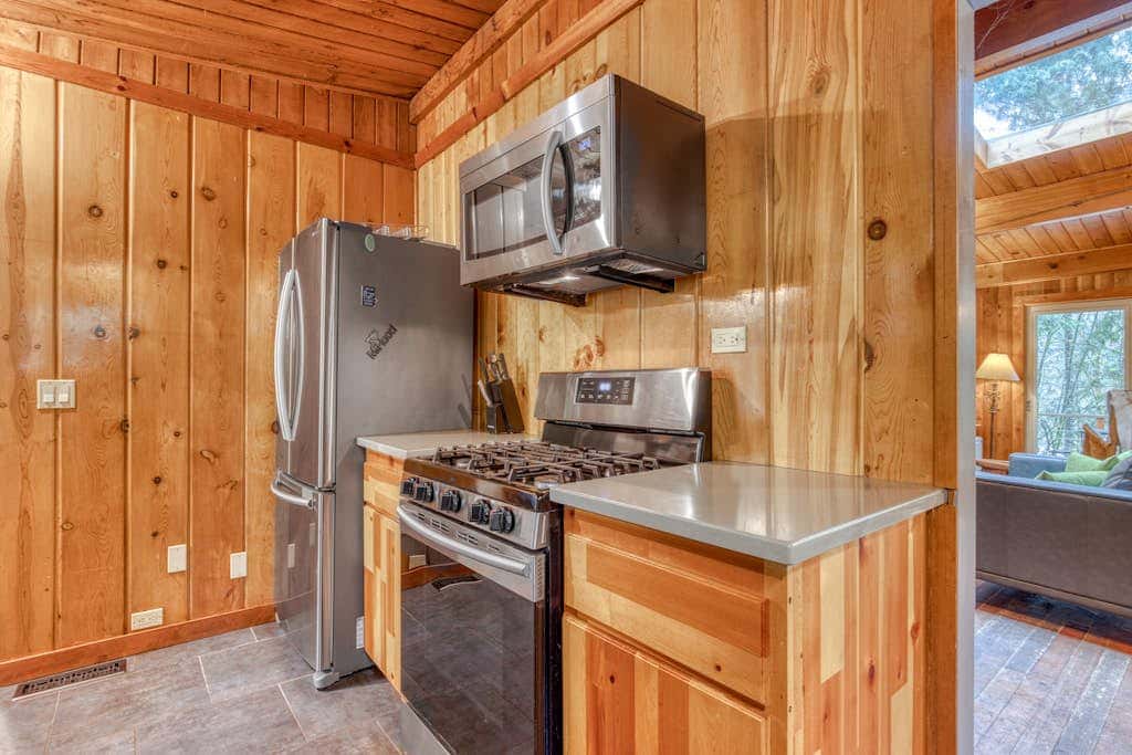 Rustic lodge with private hot tub, fireplace & riverfront views  - dog-friendly
