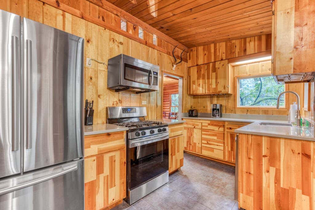 Rustic lodge with private hot tub, fireplace & riverfront views  - dog-friendly
