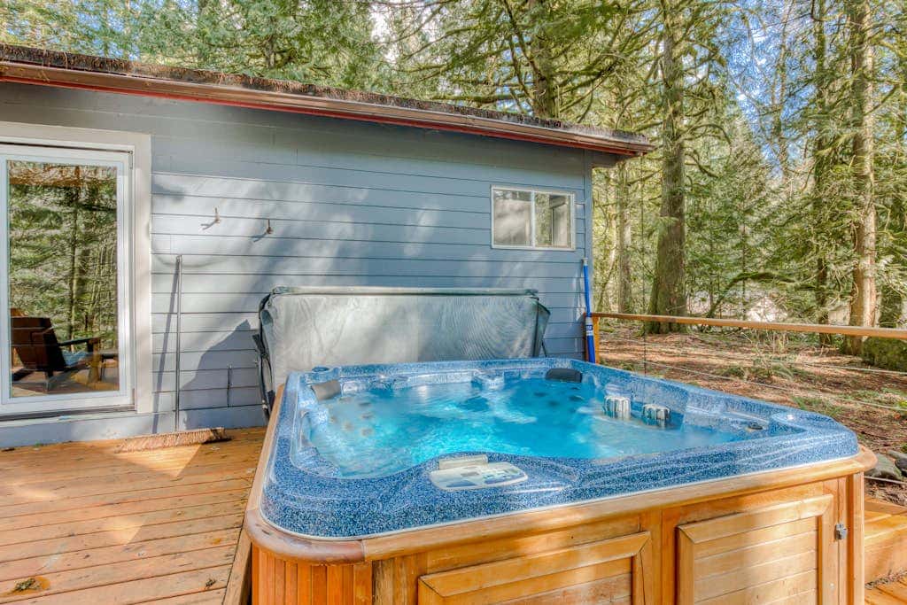 Rustic lodge with private hot tub, fireplace & riverfront views  - dog-friendly