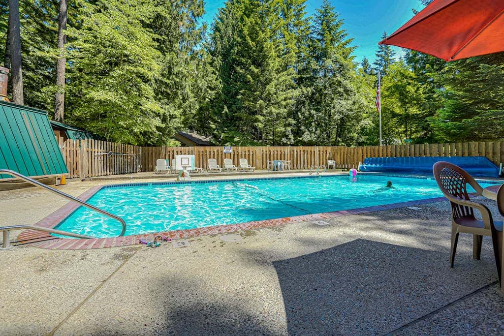 Dog-friendly home with hot tub, shared pool, firepit, fireplace, & river access