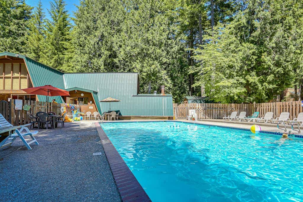 Dog-friendly home with hot tub, shared pool, firepit, fireplace, & river access