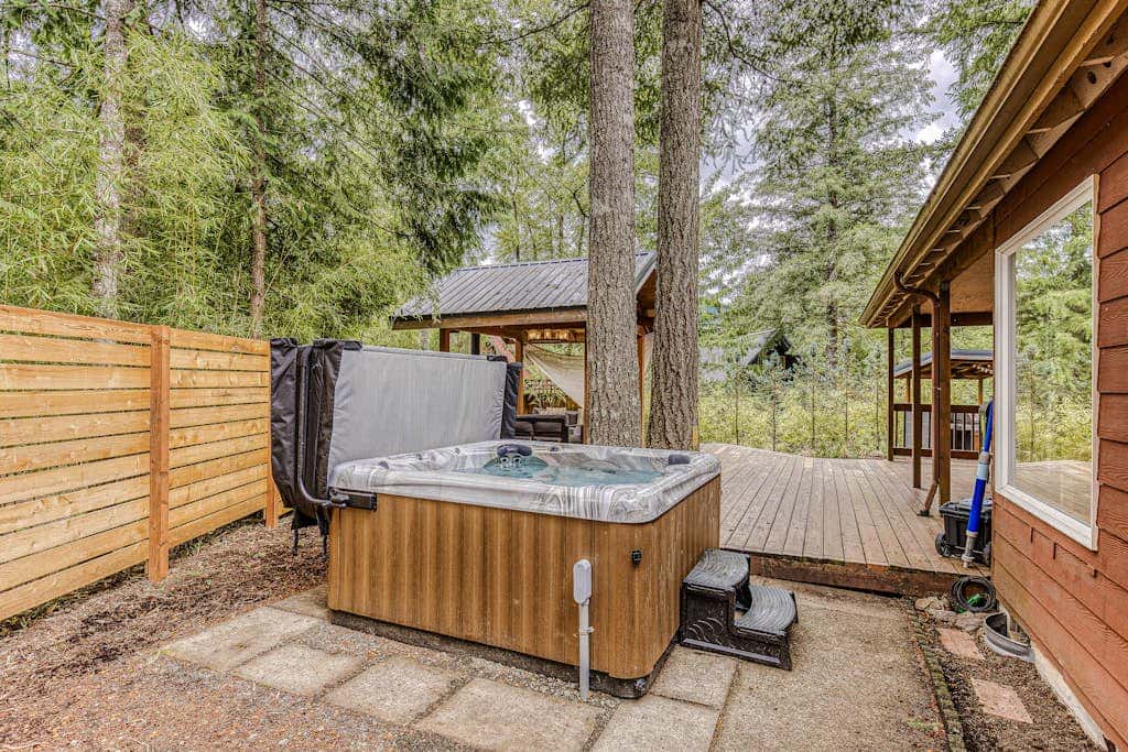 Dog-friendly home with hot tub, shared pool, firepit, fireplace, & river access