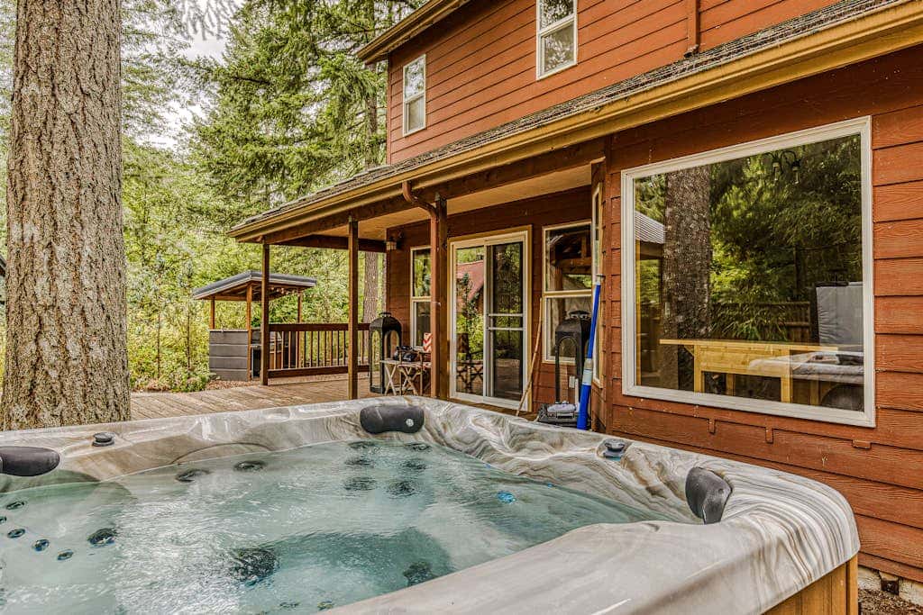 Dog-friendly home with hot tub, shared pool, firepit, fireplace, & river access