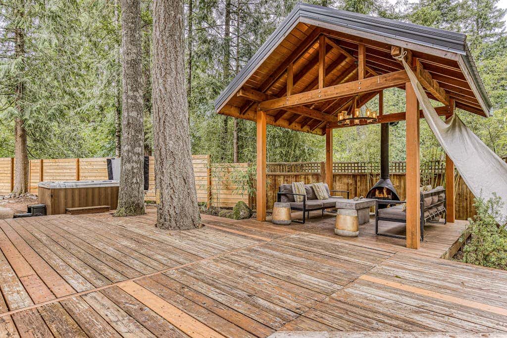 Dog-friendly home with hot tub, shared pool, firepit, fireplace, & river access