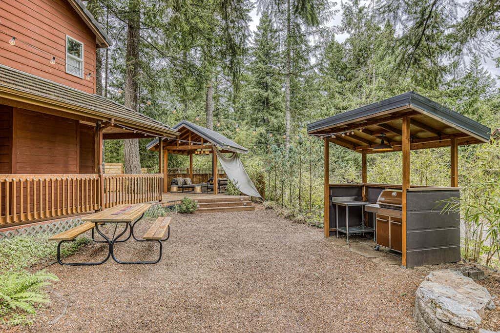 Dog-friendly home with hot tub, shared pool, firepit, fireplace, & river access