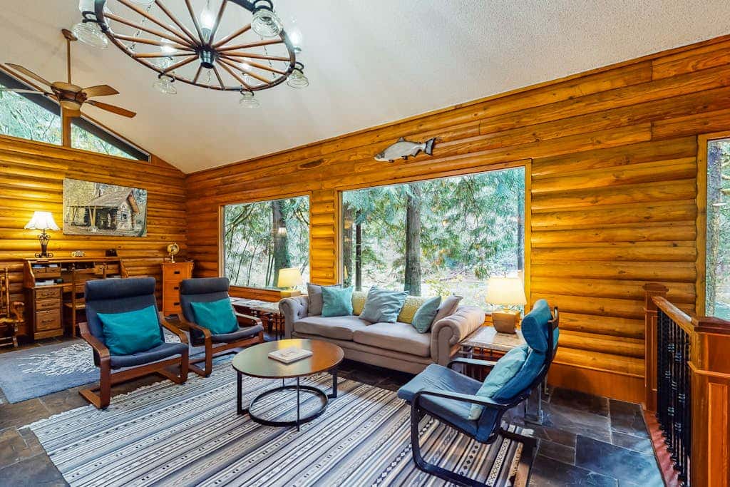 Spacious riverfront lodge with beach access, private hot tub & forest views