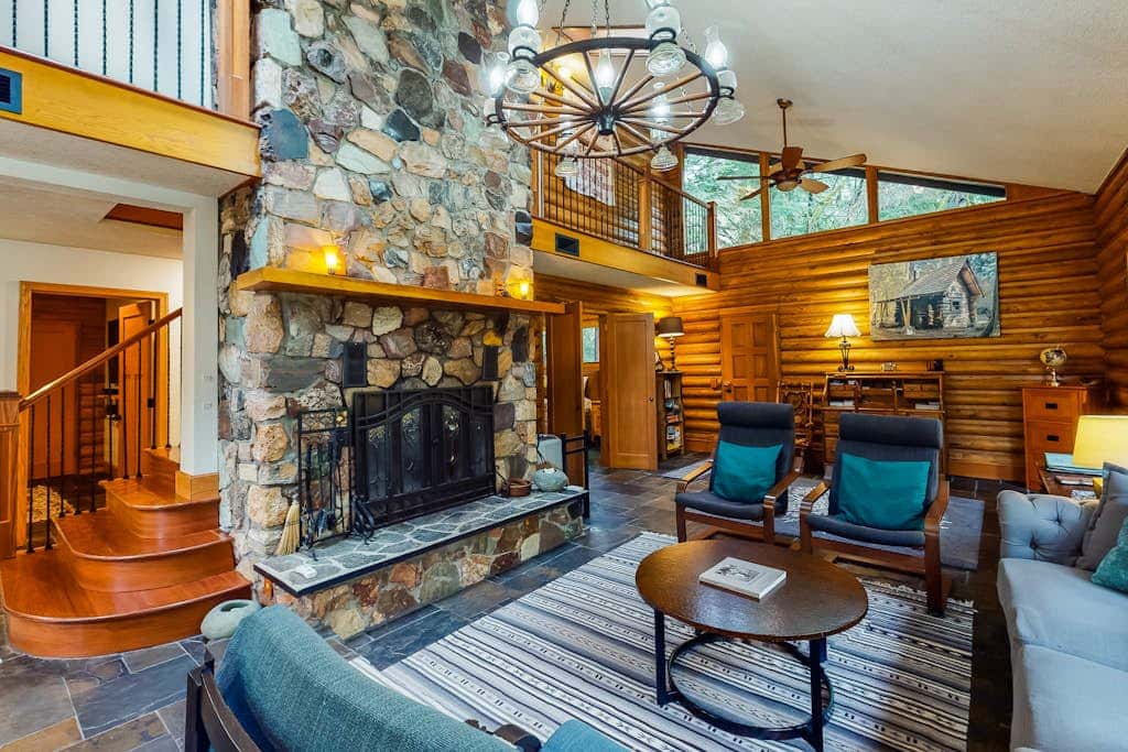 Spacious riverfront lodge with beach access, private hot tub & forest views