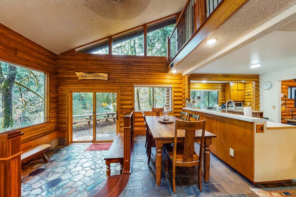 Spacious riverfront lodge with beach access, private hot tub & forest views