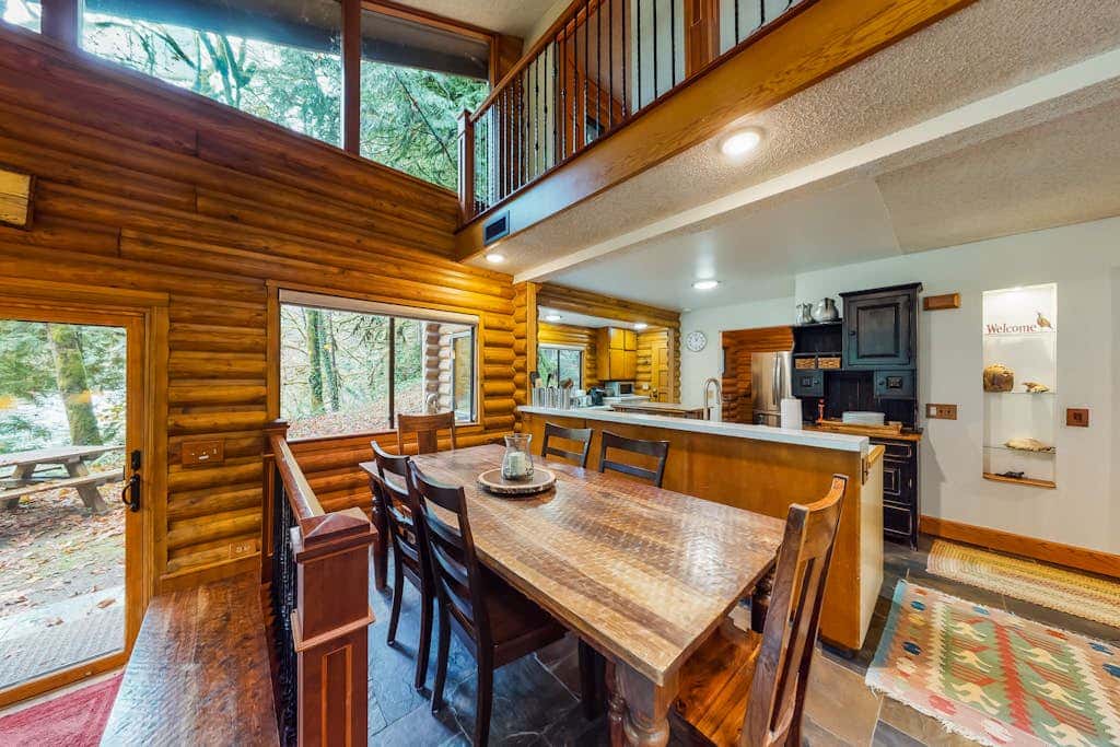 Spacious riverfront lodge with beach access, private hot tub & forest views