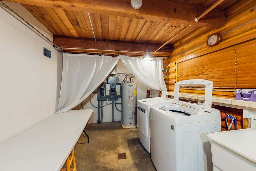 Spacious riverfront lodge with beach access, private hot tub & forest views