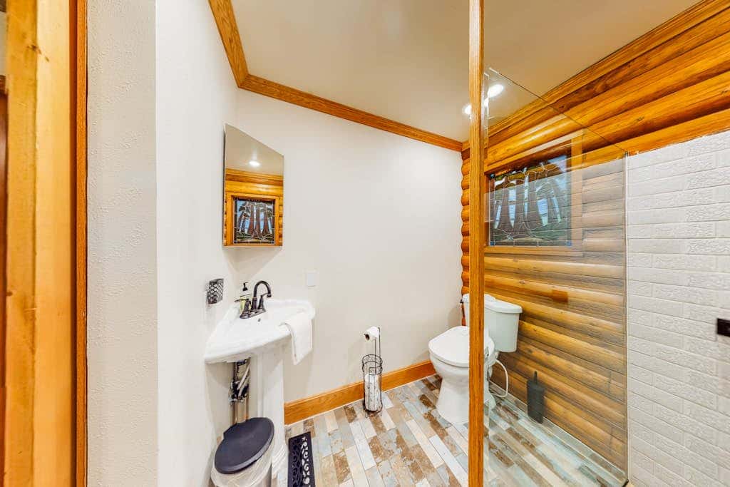 Spacious riverfront lodge with beach access, private hot tub & forest views