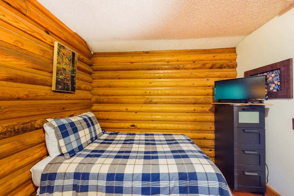 Spacious riverfront lodge with beach access, private hot tub & forest views