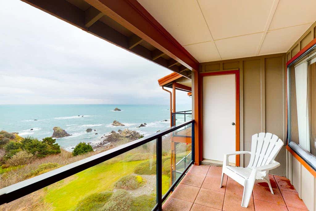 Sweeping Oceanfront Views Await Tranquil Condo with Balcony, Beach Access, W&D