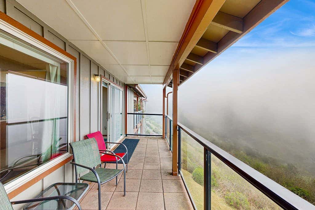 Sweeping Oceanfront Views Await Tranquil Condo with Balcony, Beach Access, W&D