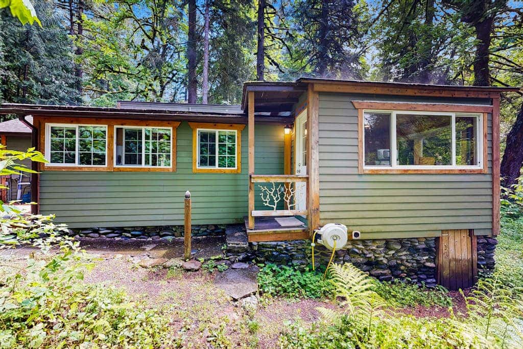 Cozy Riverfront Cottage with Charming Interior & Hot Tub - Dog-Friendly