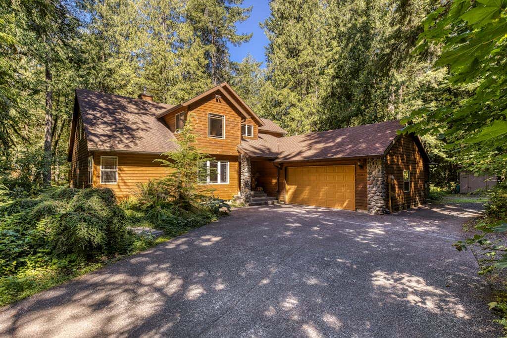 Classic riverfront home with great views, game room, hot tub, & modern cabin feel