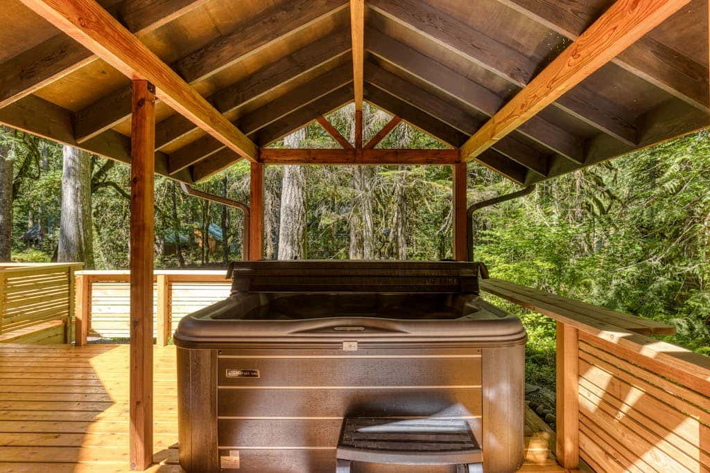 Classic riverfront home with great views, game room, hot tub, & modern cabin feel