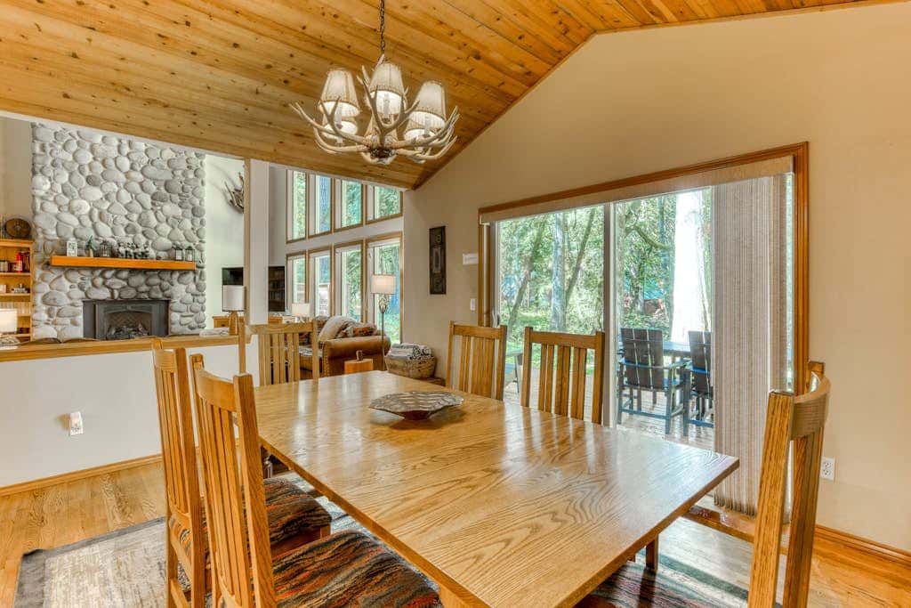 Classic riverfront home with great views, game room, hot tub, & modern cabin feel