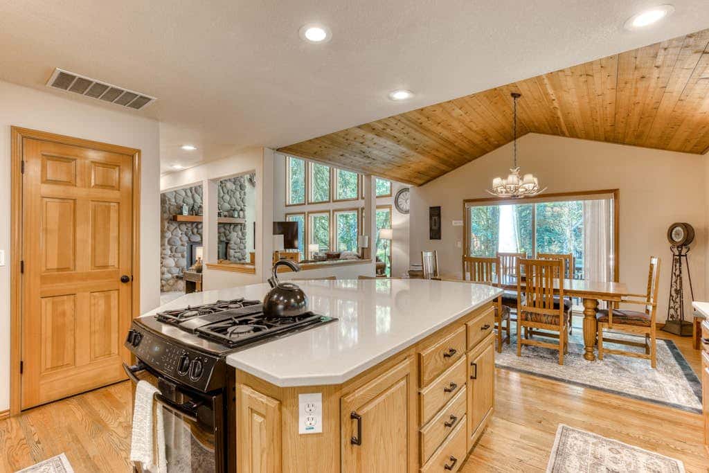 Classic riverfront home with great views, game room, hot tub, & modern cabin feel