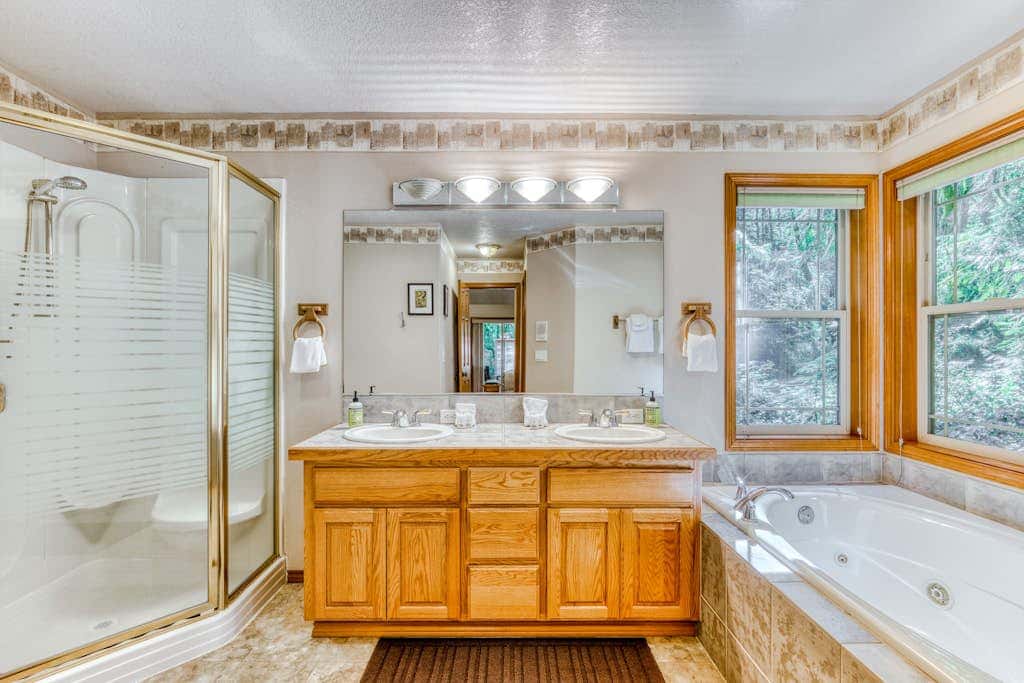 Classic riverfront home with great views, game room, hot tub, & modern cabin feel