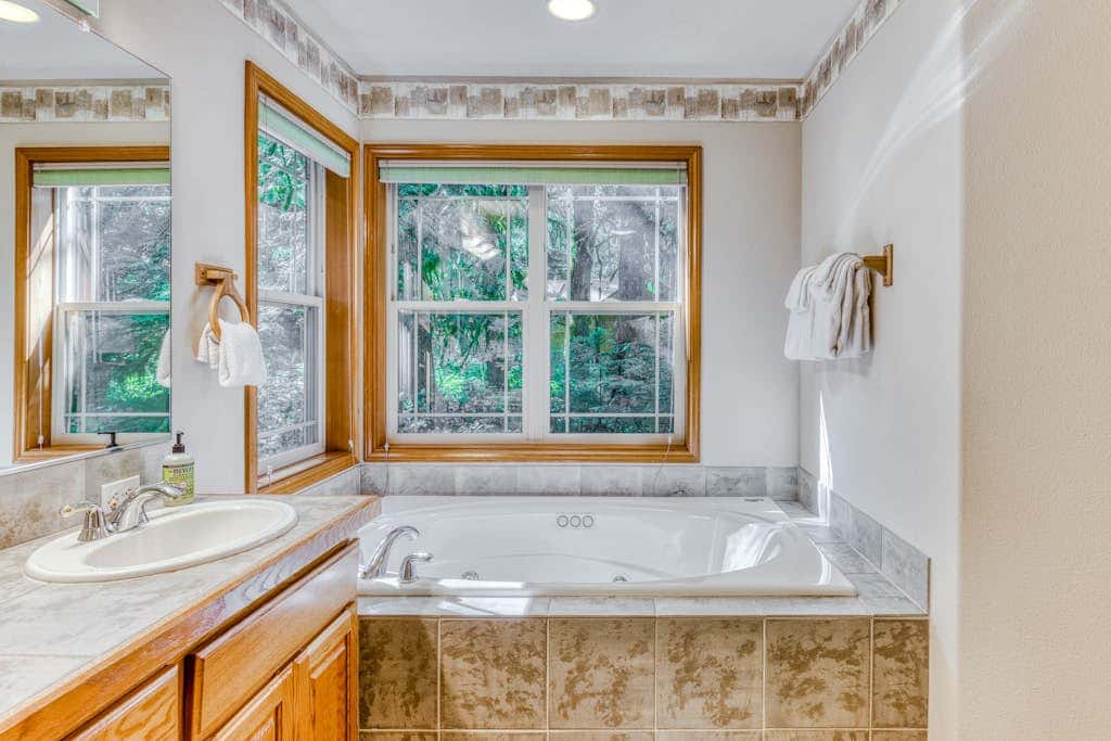 Classic riverfront home with great views, game room, hot tub, & modern cabin feel