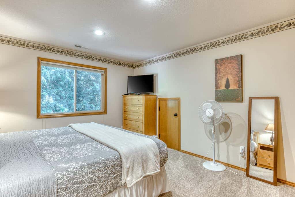 Classic riverfront home with great views, game room, hot tub, & modern cabin feel