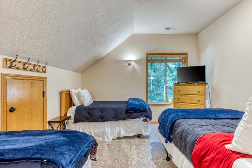 Classic riverfront home with great views, game room, hot tub, & modern cabin feel