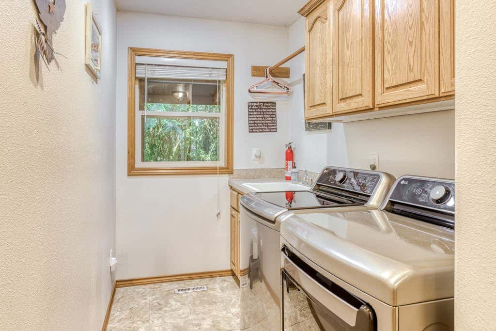 Classic riverfront home with great views, game room, hot tub, & modern cabin feel