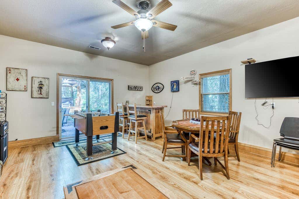 Classic riverfront home with great views, game room, hot tub, & modern cabin feel