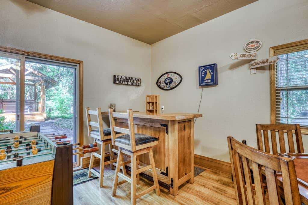 Classic riverfront home with great views, game room, hot tub, & modern cabin feel