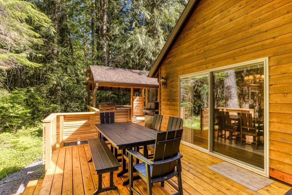 Classic riverfront home with great views, game room, hot tub, & modern cabin feel