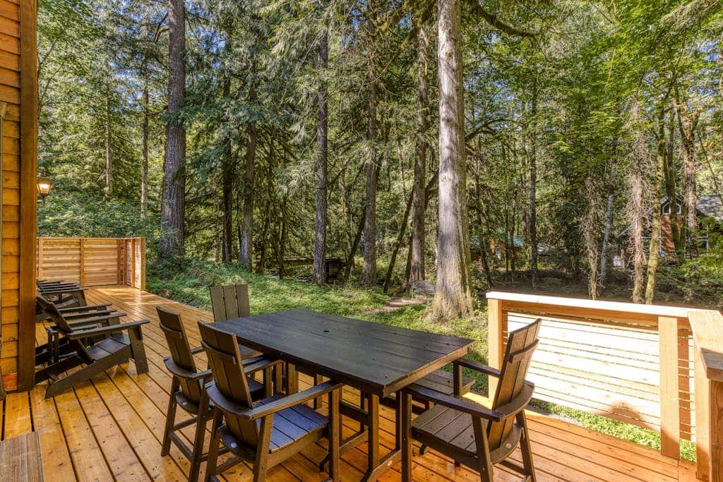 Classic riverfront home with great views, game room, hot tub, & modern cabin feel