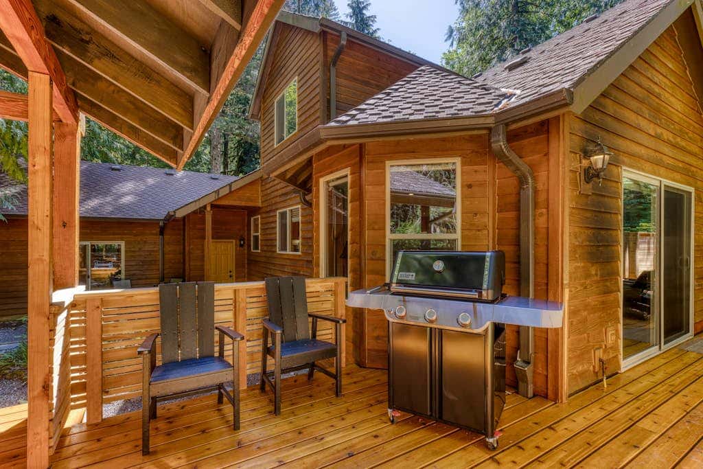 Classic riverfront home with great views, game room, hot tub, & modern cabin feel